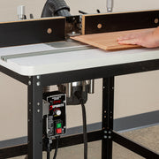 Router table with a person using it to cut wood, featuring a large LED read-out.